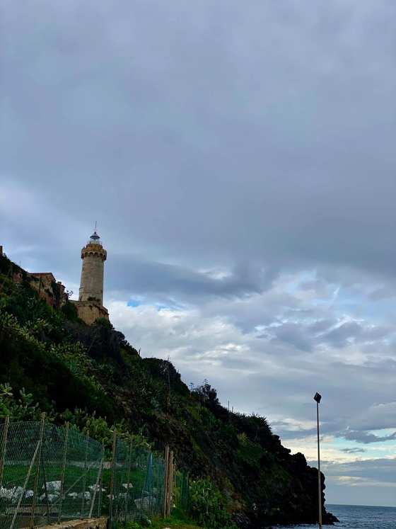 Il faro sul promontorio di Portoferraio, visto dal basso sotto un cielo nuvoloso